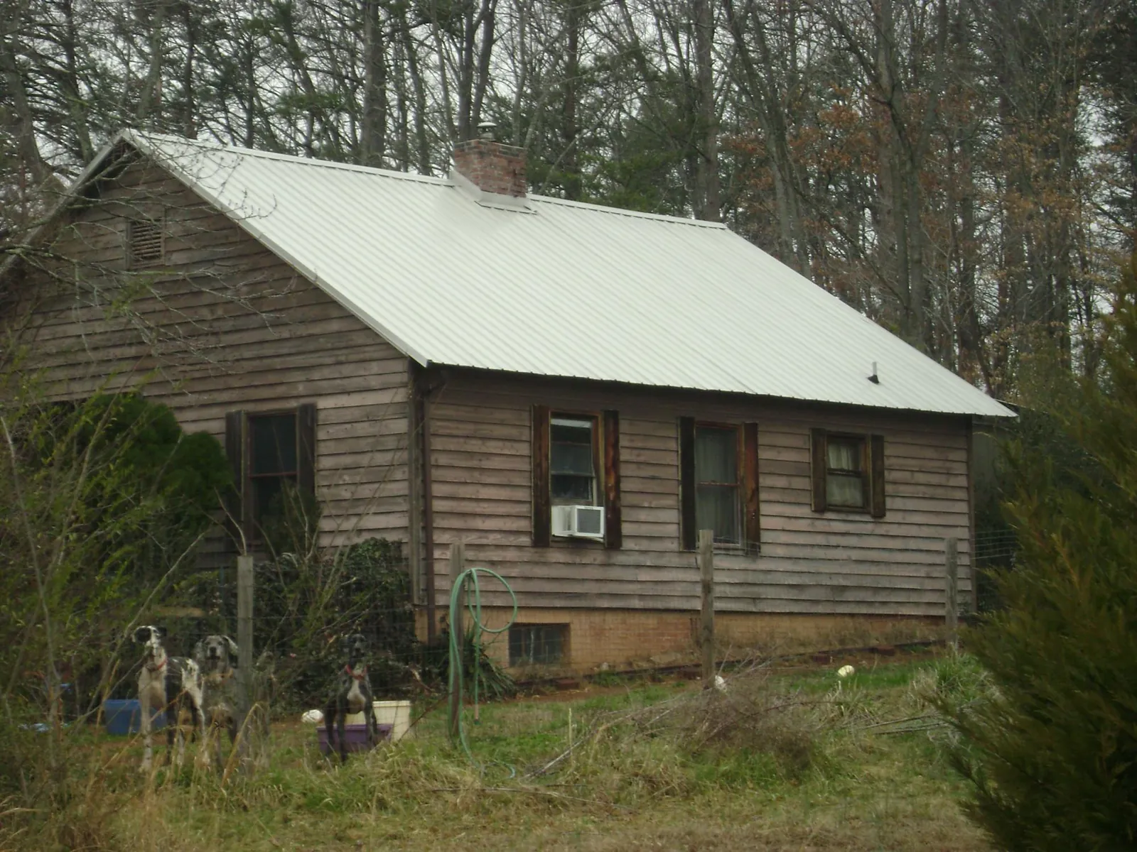 White metal roof on an old wood sided farmhouse, from a Metal Roof Installation job in Villas